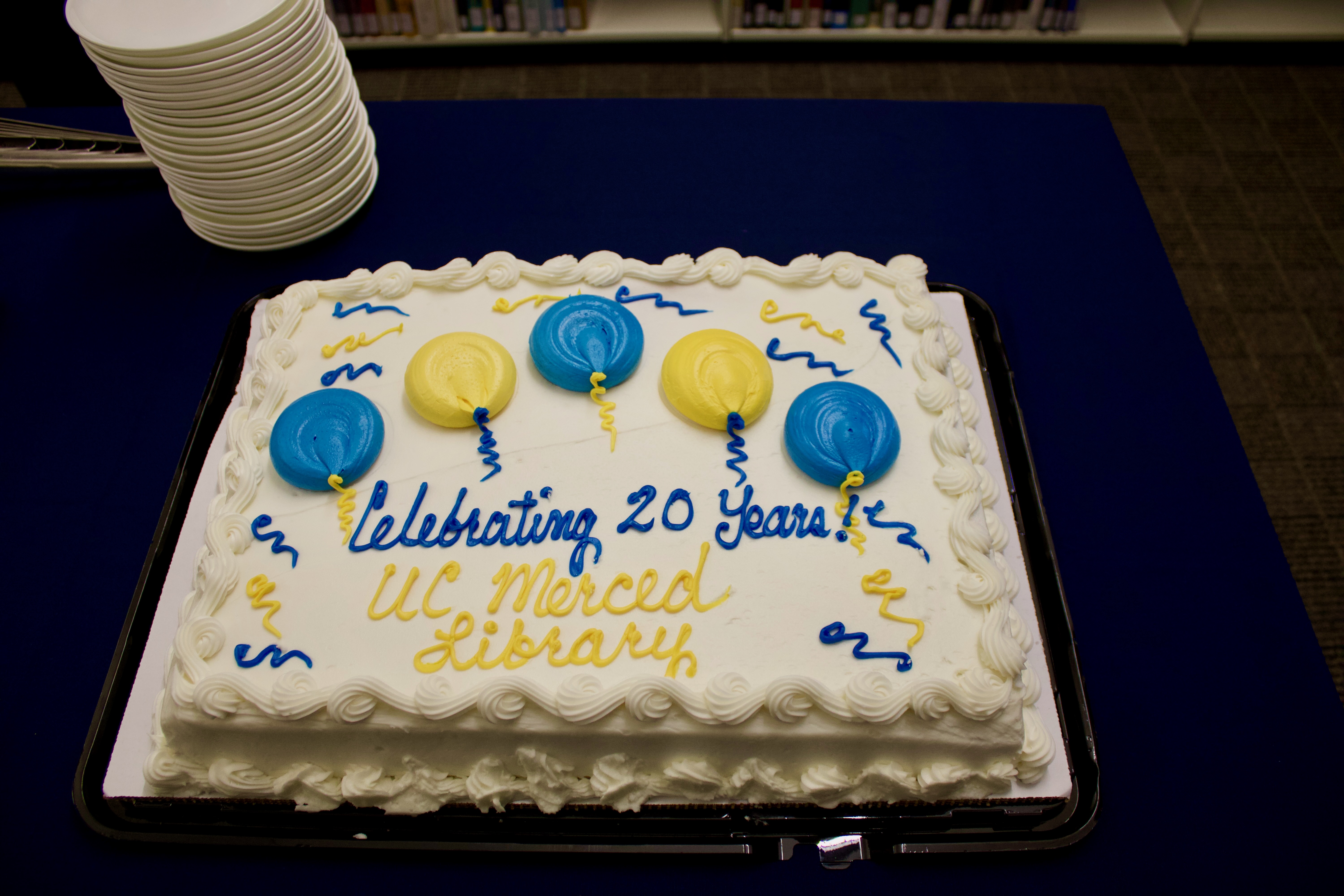 Sheet cake decorated with blue and yellow ballons with text: Celebrating 20 Years UC Merced Library