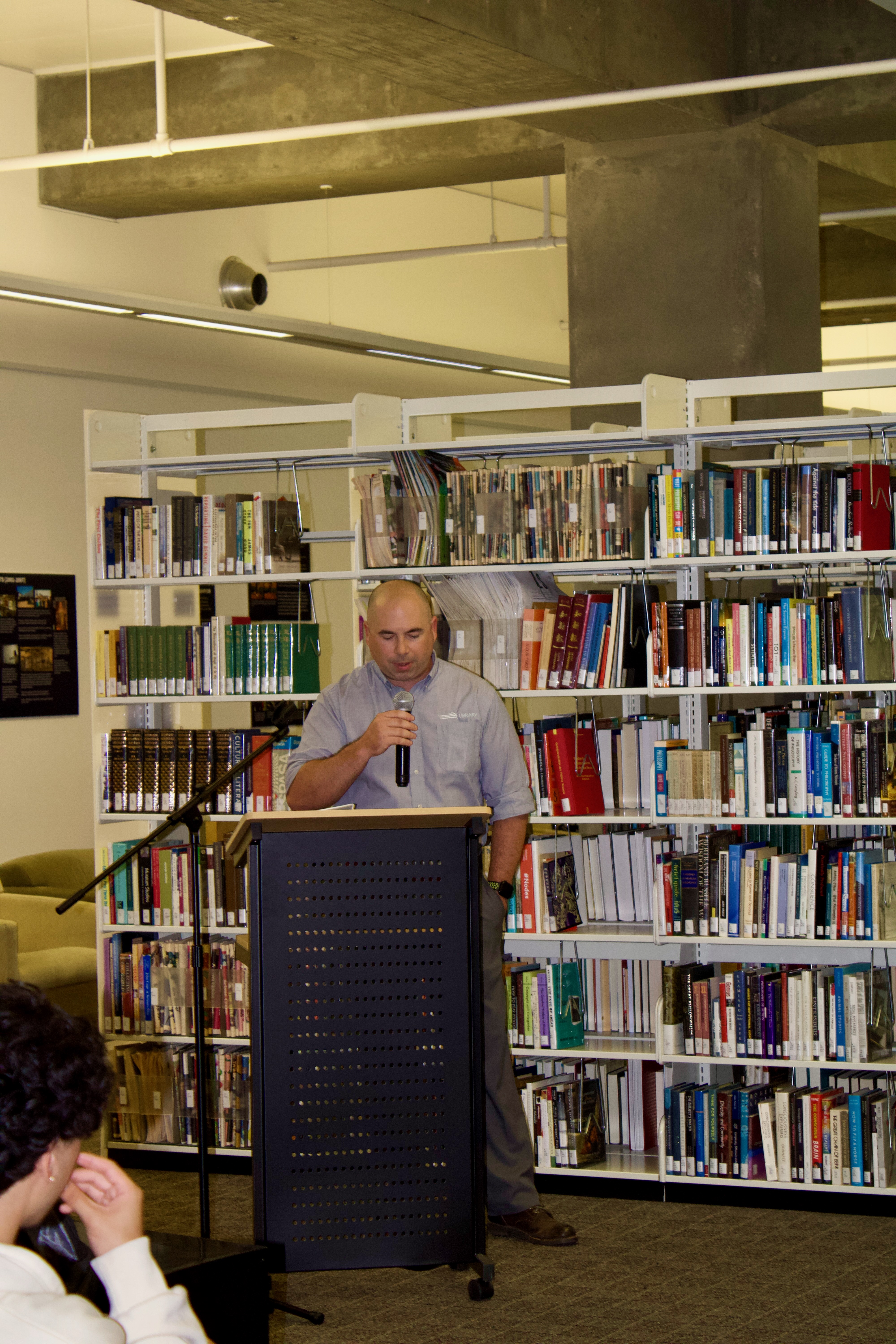 Joe Ameen, Research & Learning Librarian and Class of 2009 alum, read remarks of Founding University Librariana, R Bruce Miller