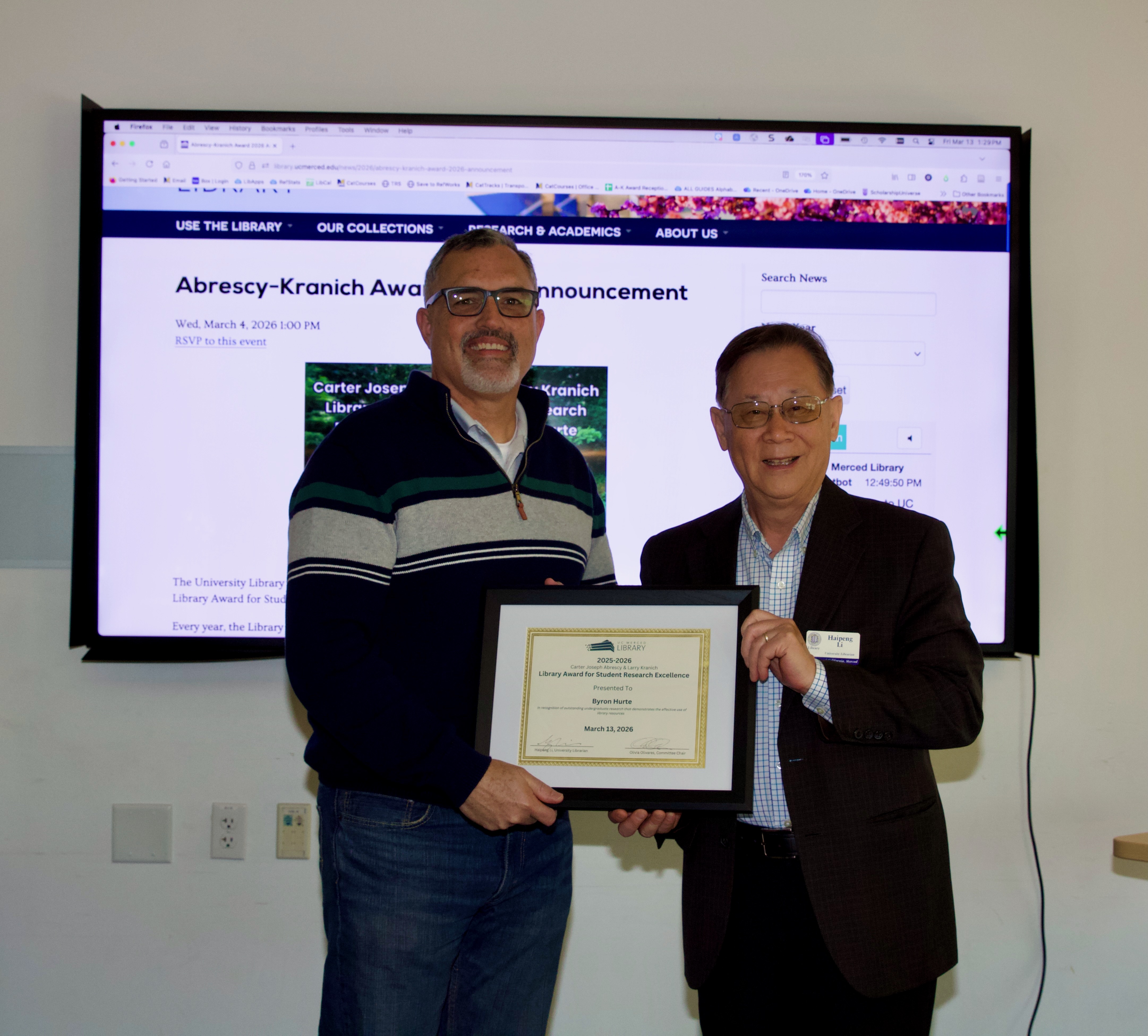 Byron Hurte, research award winner and Haipeng Li, University Librarian, hold framed award certificate