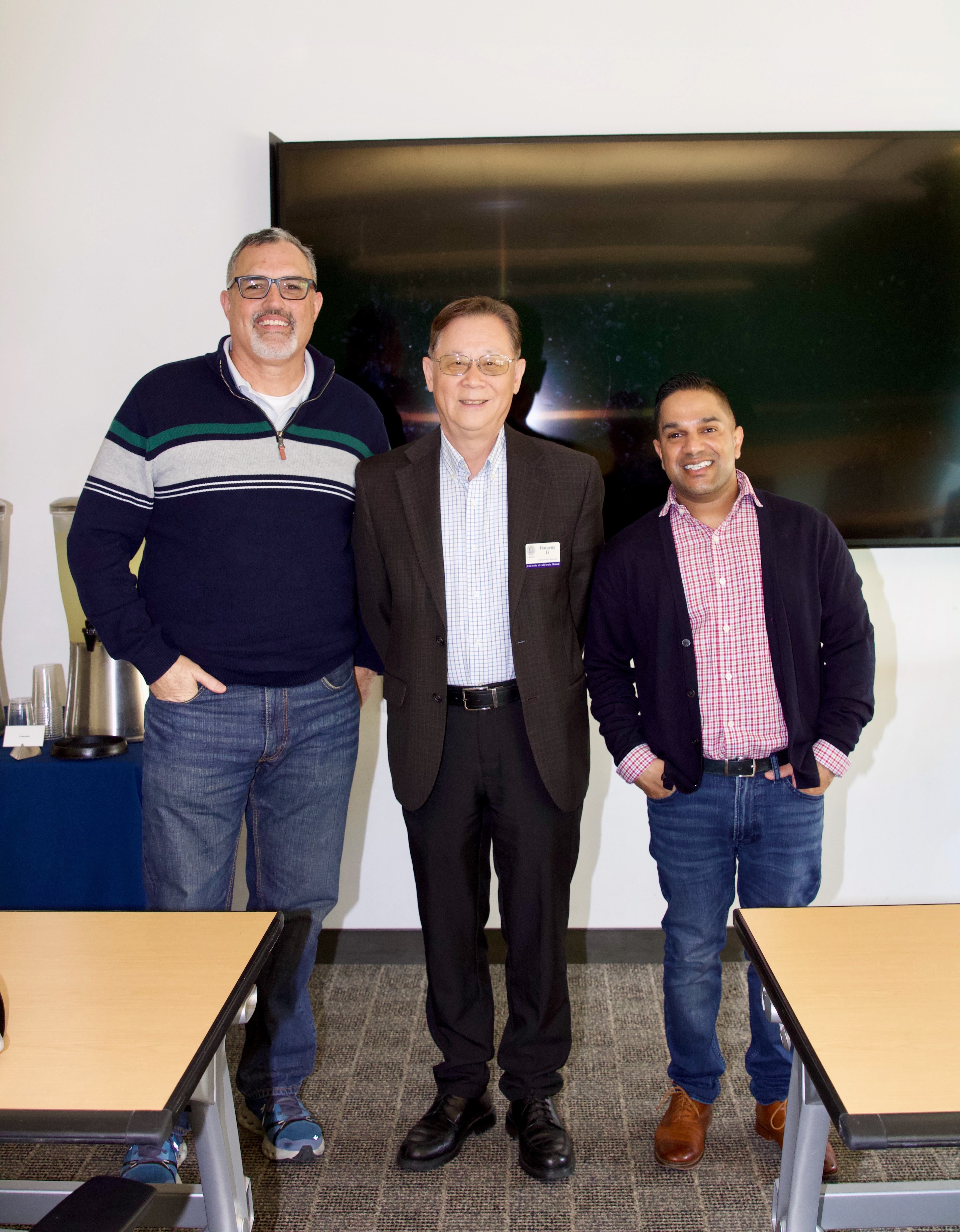 Bryon Hurte, Haipeng Li, and Professor Ali stand and face camera
