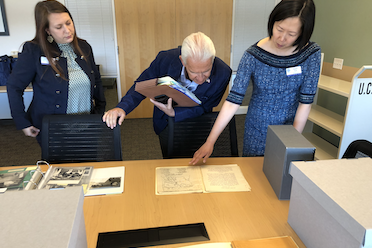 Costa views items from the archives