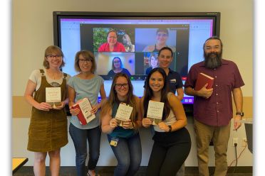 Group photo of Staff holding books