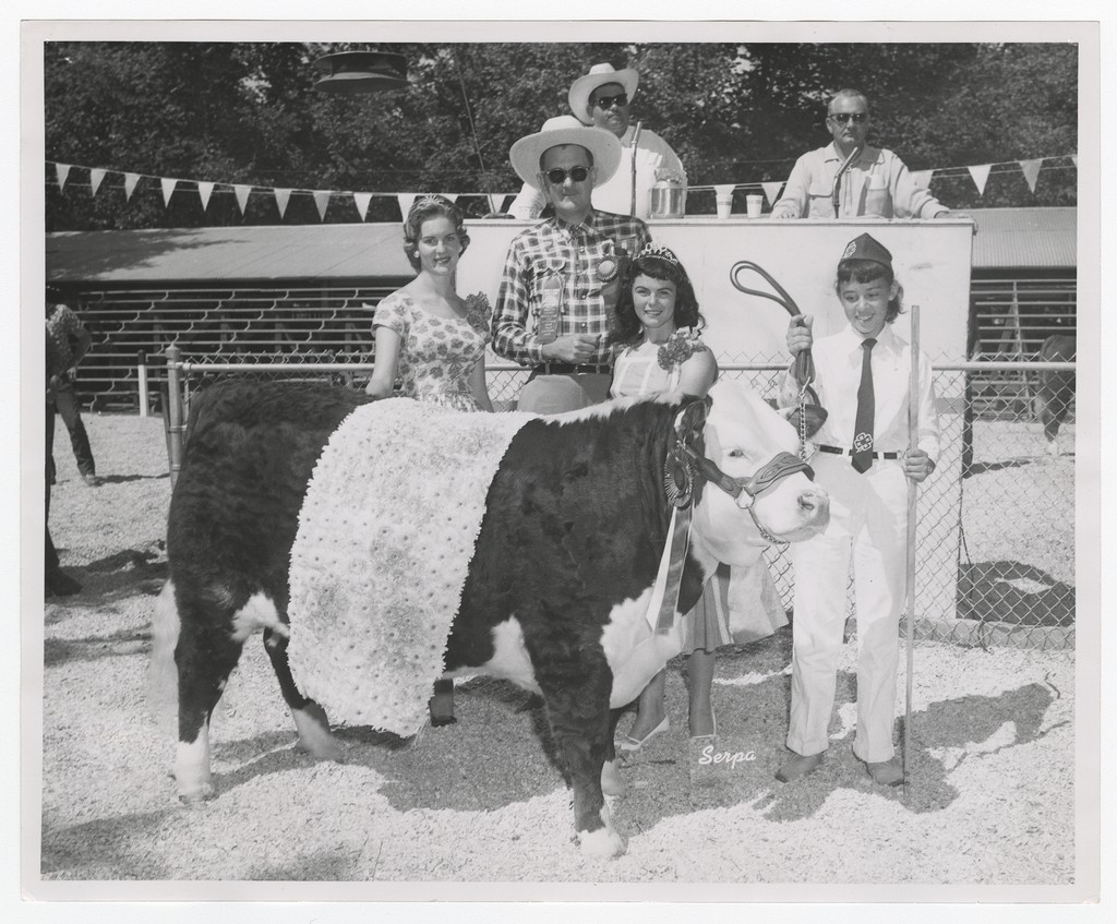 Group with prize-winning cow, circa 1963. Merced County UC Cooperative Extension Records.