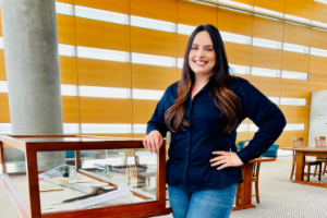 photo of Fabiola Chavez standing near library display case