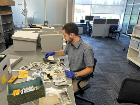 Tyler processes photographs and negatives from the UCCE Fresno collection